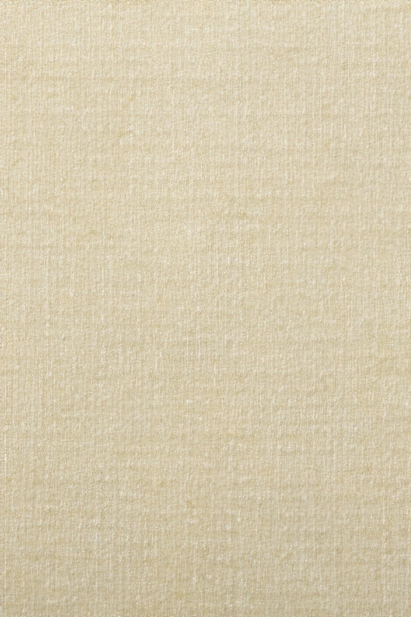 Close detail of a sand-coloured chenille upholstery weave, warp visible through the pile.